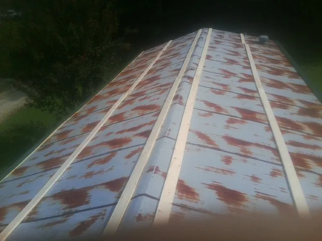 Rusted metal roof panels with new wood purlins before replacement — Storm Damage Roof Repair in Ossining by Roofing Brothers